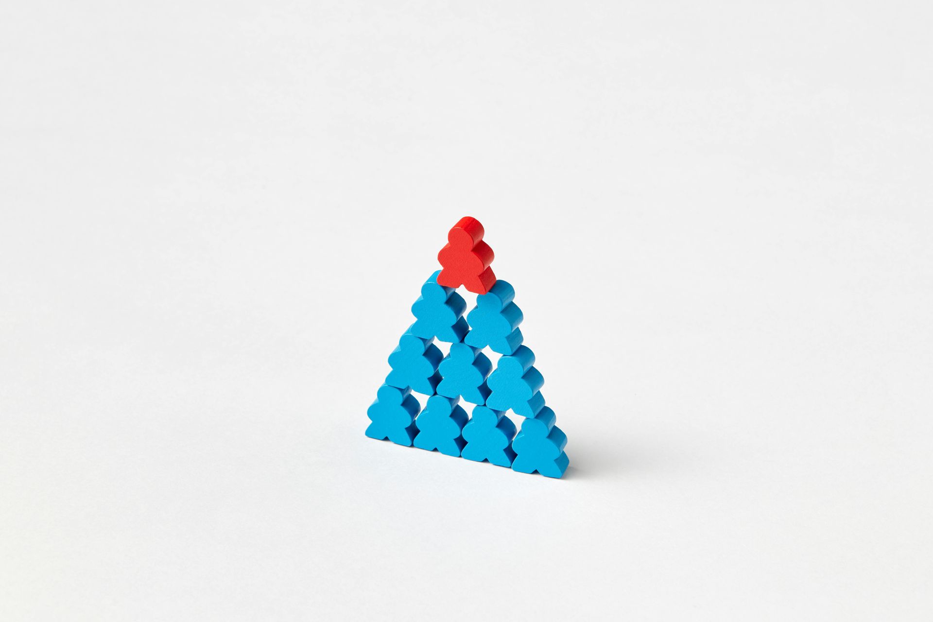 Little gingerbread men in a pyramid shape. All the people are blue, apart from the red one on top.