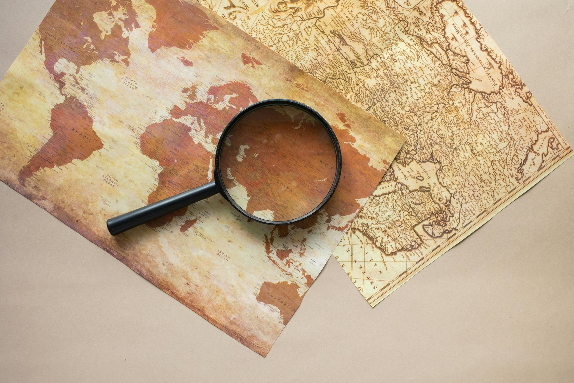 Magnifying glass on an old sepia map
