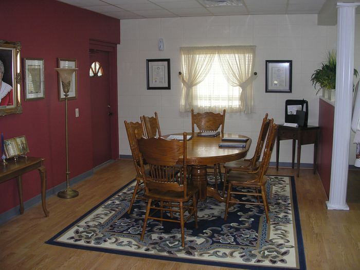 a dining room with a table and chairs and a rug