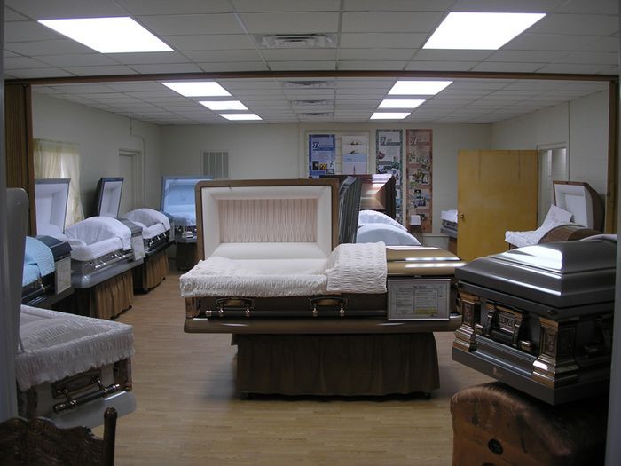 a room full of coffins including one that is open