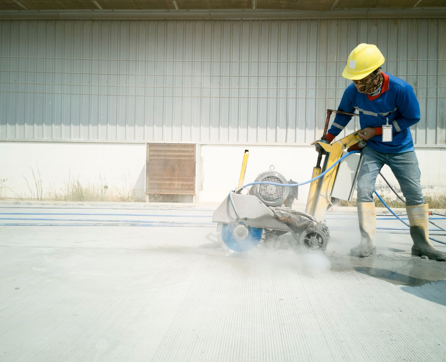 A contractor cutting control joint concrete.