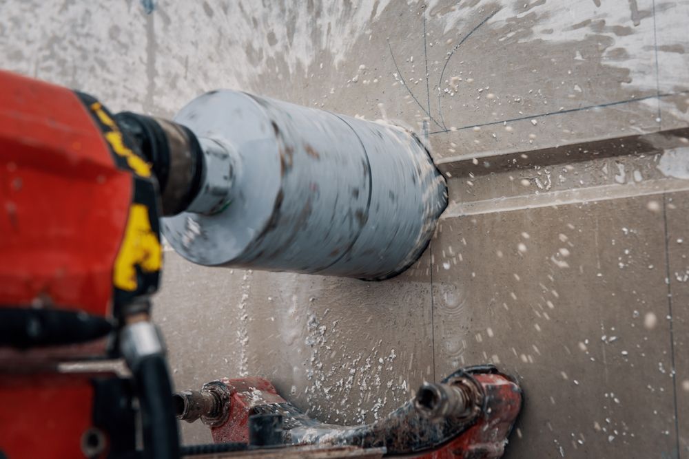 A person is using a drill to drill a hole in a wall.