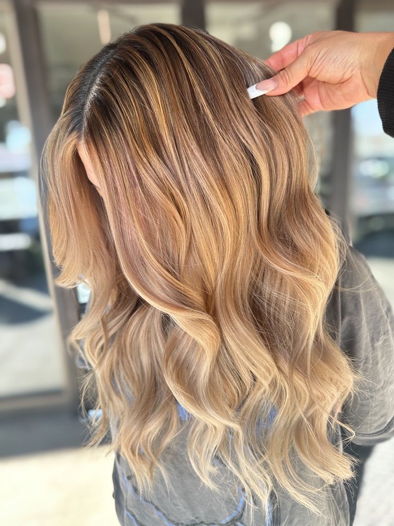 A woman is getting her hair done by a hairdresser.