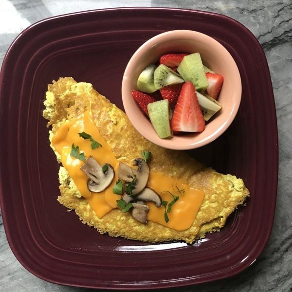 Mushroom and Cheese Omelette on plate with fruit