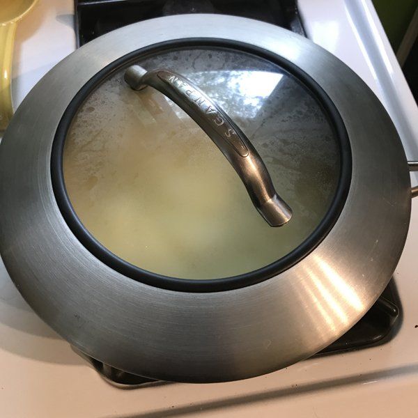 tofu omelette ingredients in cast iron skillet with lid