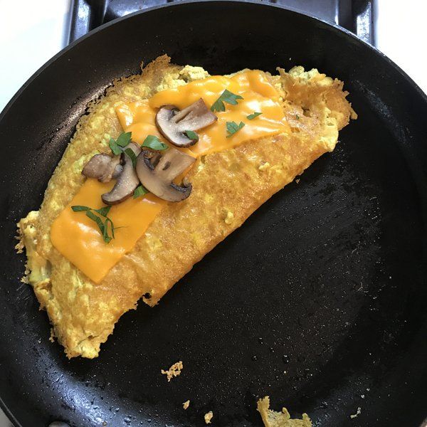 tofu omelette ingredients in cast iron skillet flipped over