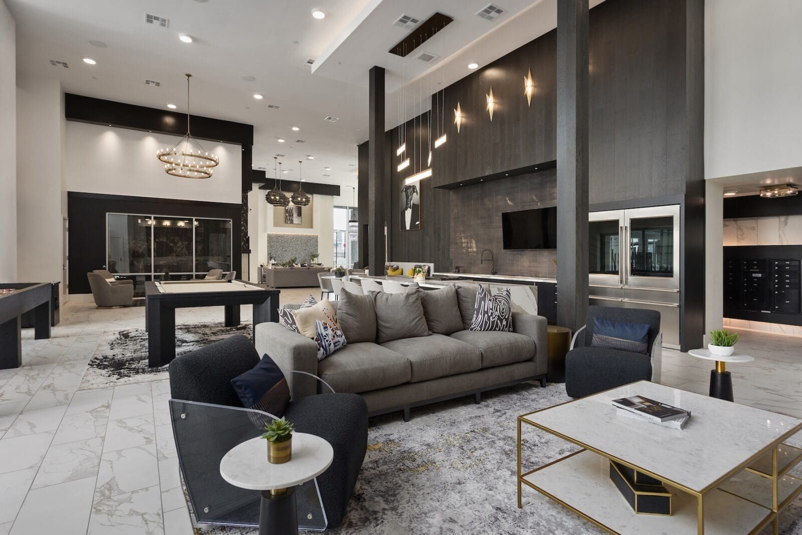 Modern apartment lobby with gray seating, marble floors, and black accents at Echo Biltmore in Phoenix, AZ..