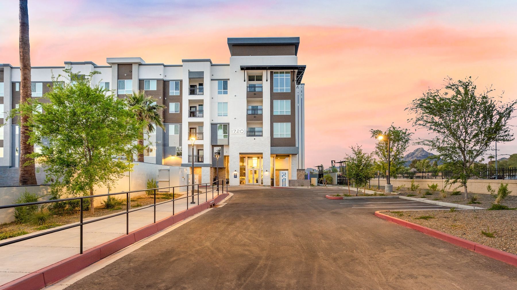 Modern apartment building with a driveway at sunset at Echo Biltmore in Phoenix, AZ..