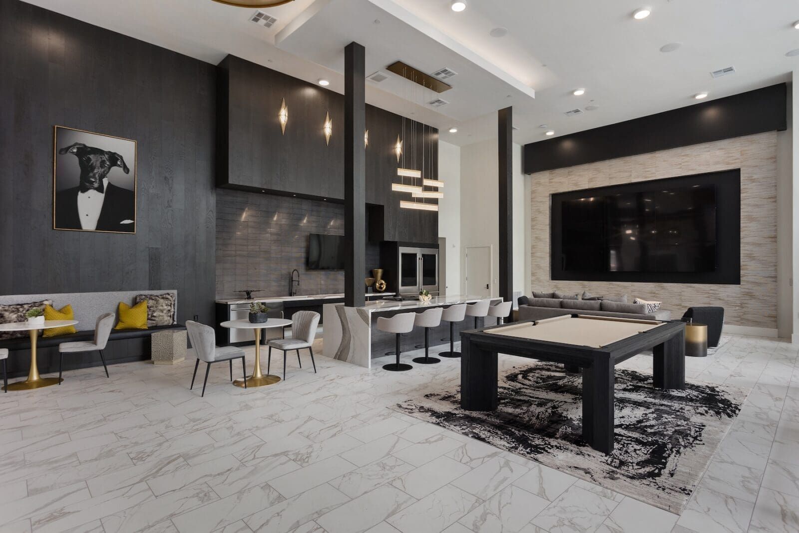 Luxurious, modern living space with kitchen, seating area, and pool table. Black, white, and gray color scheme at Echo Biltmore in Phoenix, AZ..