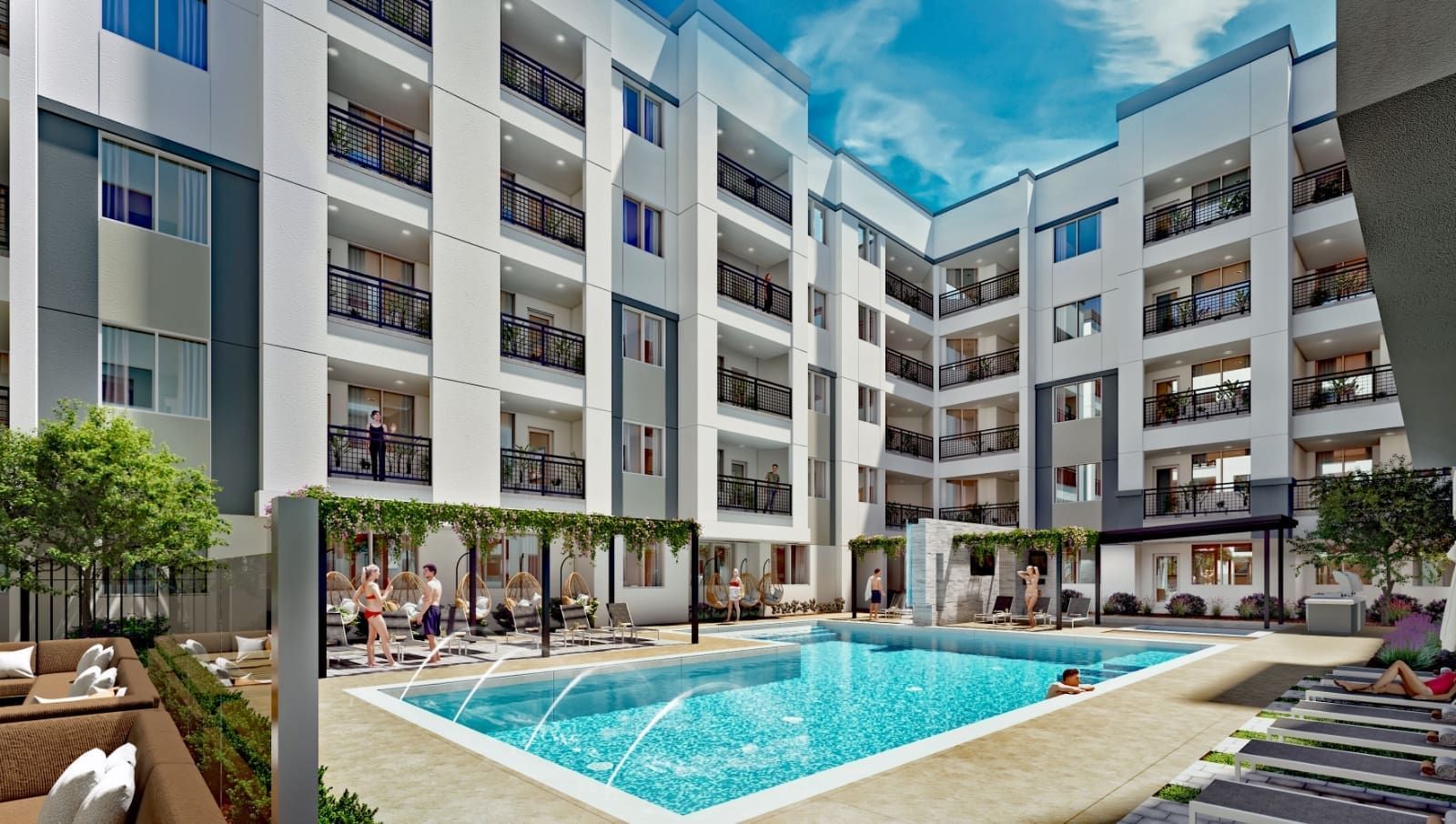Apartment complex with pool, people lounging and swimming, under a sunny sky at Echo Biltmore in Phoenix, AZ..