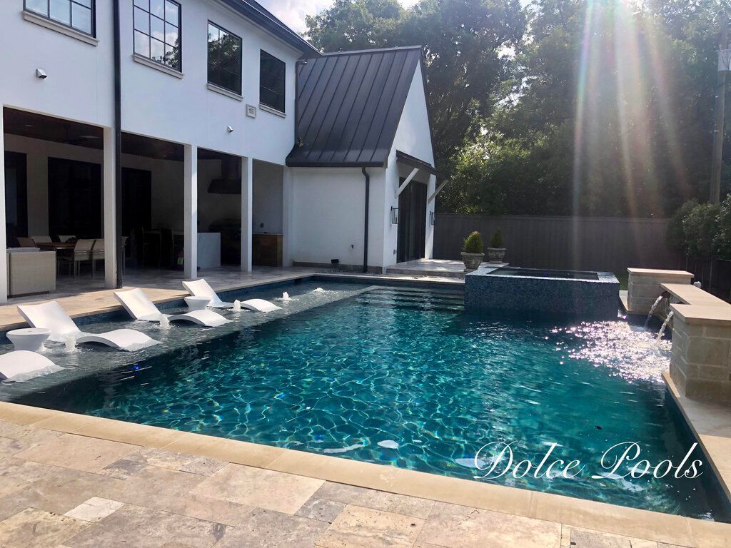 backyard custom pool with lounge chairs
