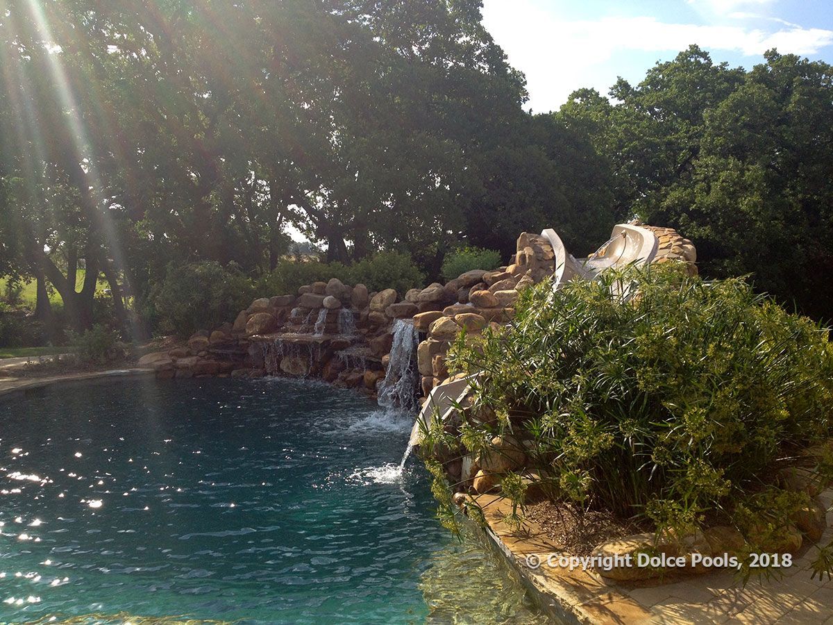 custom natural pool with rock waterfall