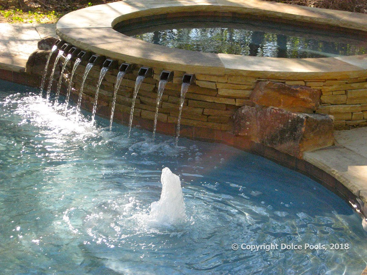 luxury spa with waterfalls into pool