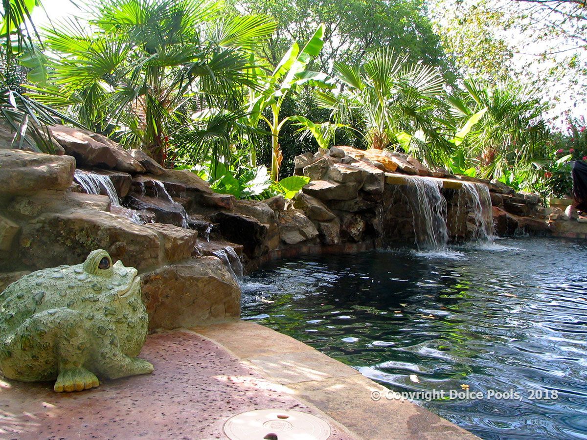 natural luxury custom pool with rock outcropping