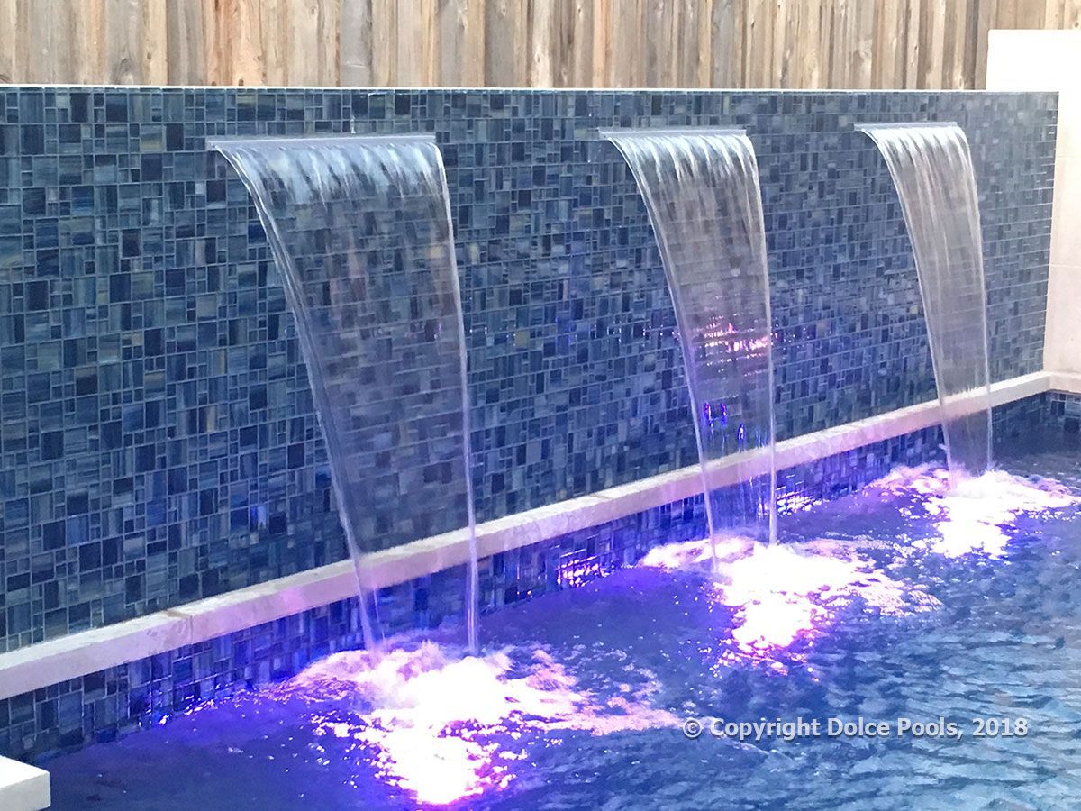 tiled waterfalls spilling into luxury pool