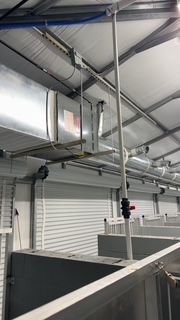 A building with a lot of pipes hanging from the ceiling.