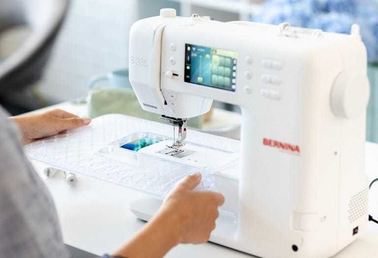 Sewing machine on a worktable bathed in warm sunlight