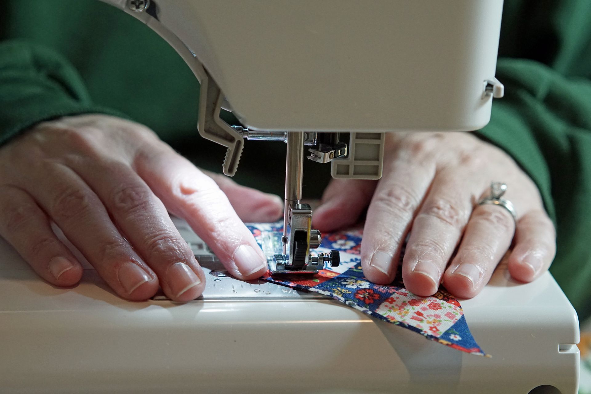 Seamstress working at a sewing machine at Hi Fashion