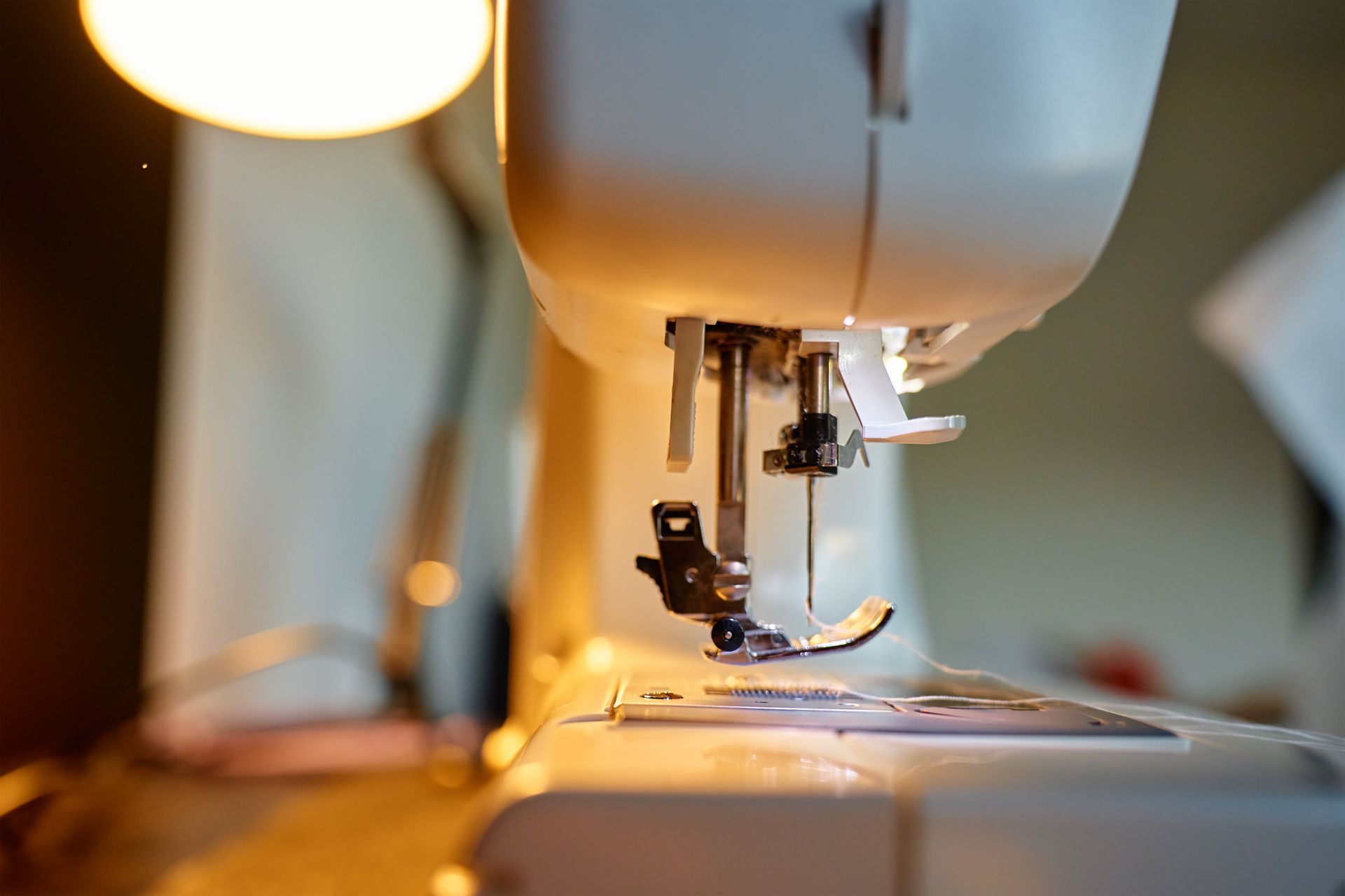 Close-up of a sewing machine needle and presser foot ready for stitching