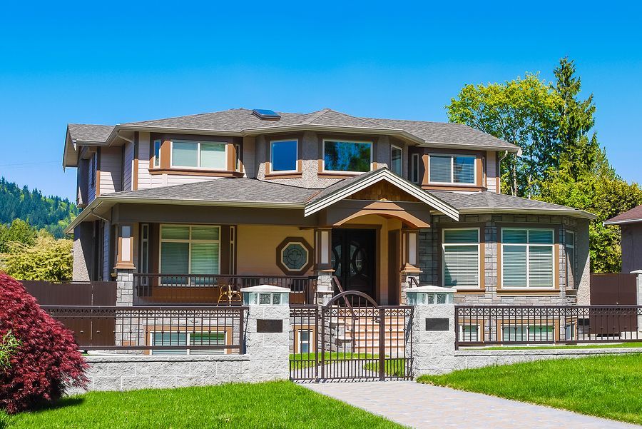 A large house with a fence in front of it