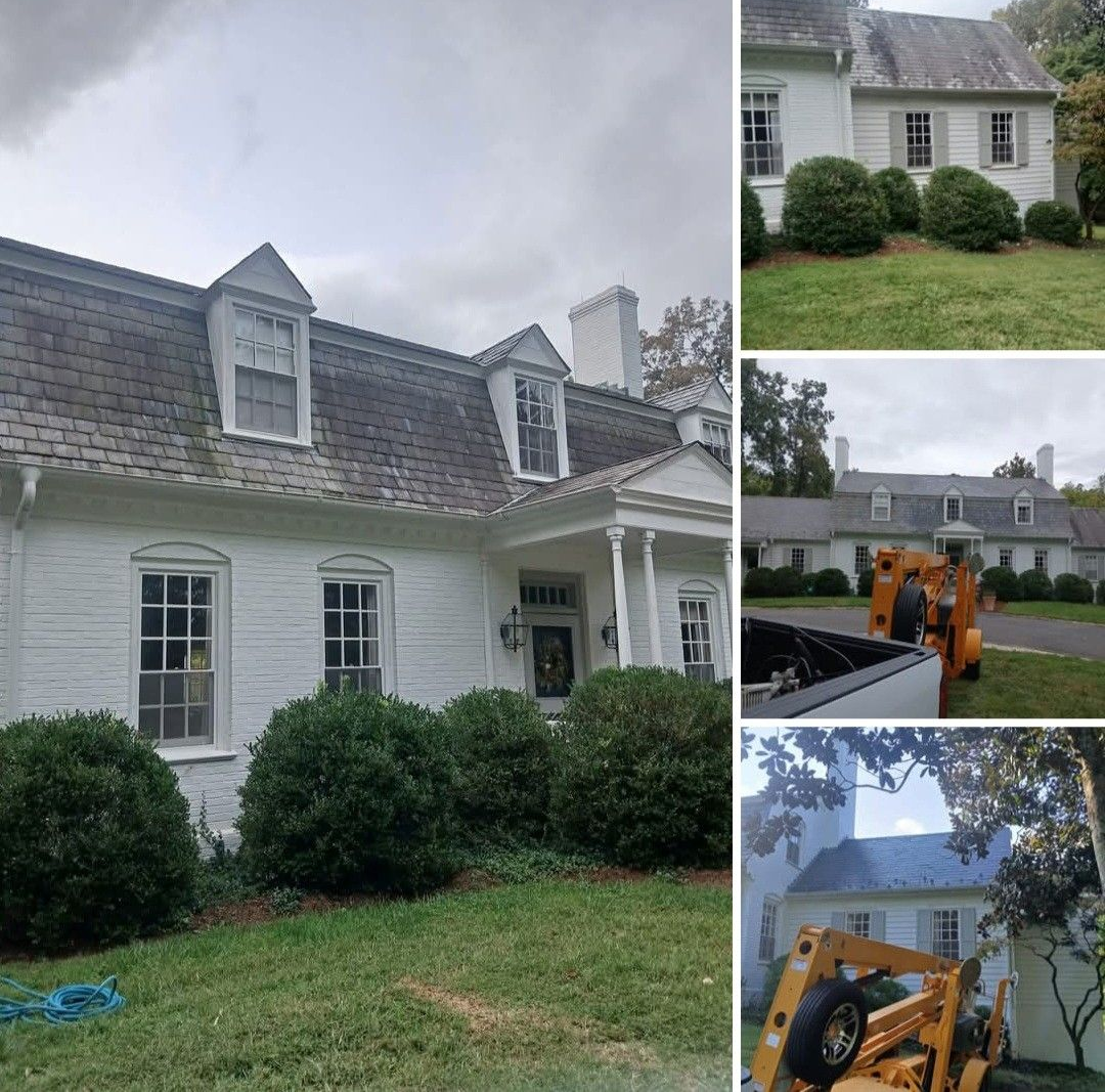 Two matte black pendant lights hanging from a white ceiling with dark structural beams and recessed spotlights.
