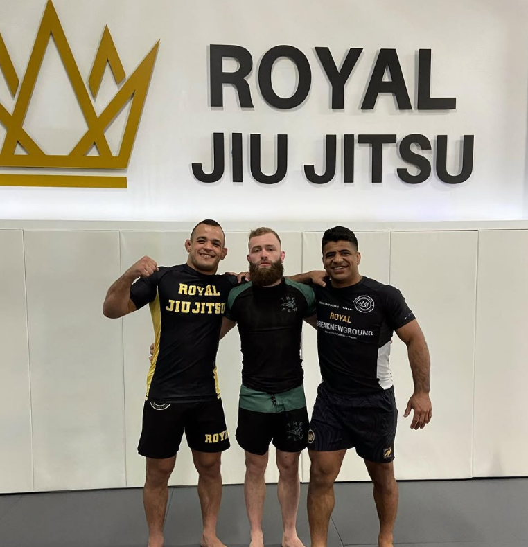 Adult students sparring and smiling after class at Royal Jiu-Jitsu Queens in Queens, NY, building fitness and friendships
