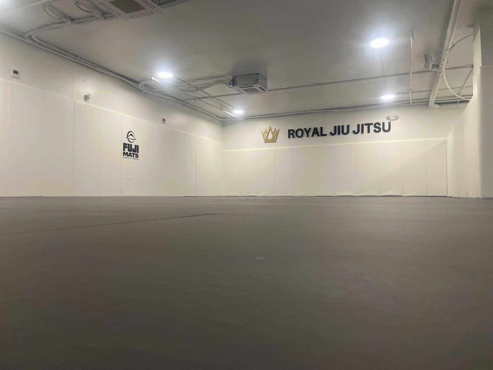 Adults drilling Brazilian Jiu Jitsu techniques at Royal Jiu-Jitsu Queens in Queens, NY for fitness and self-defense.