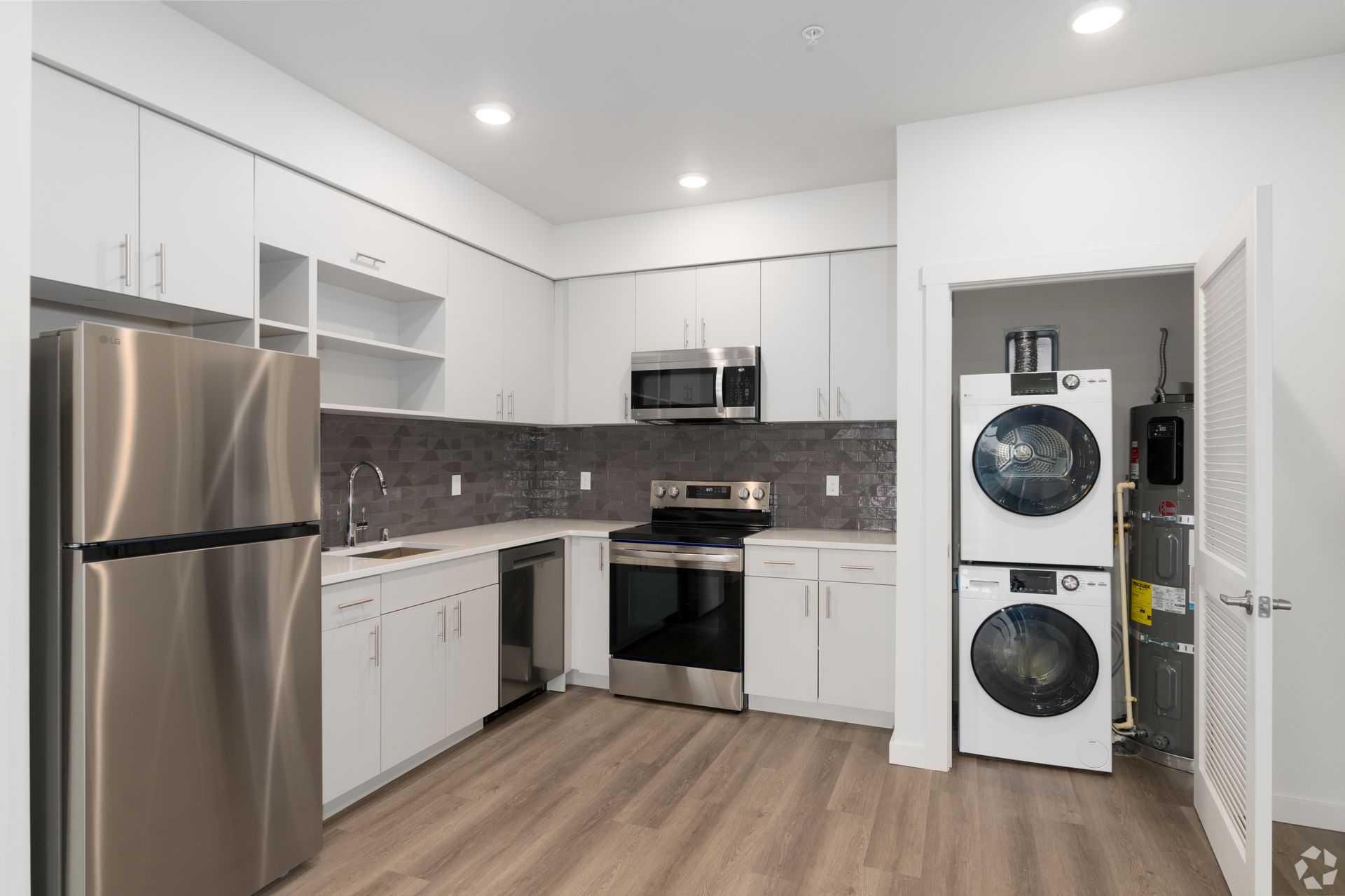 A kitchen with stainless steel appliances and white cabinets