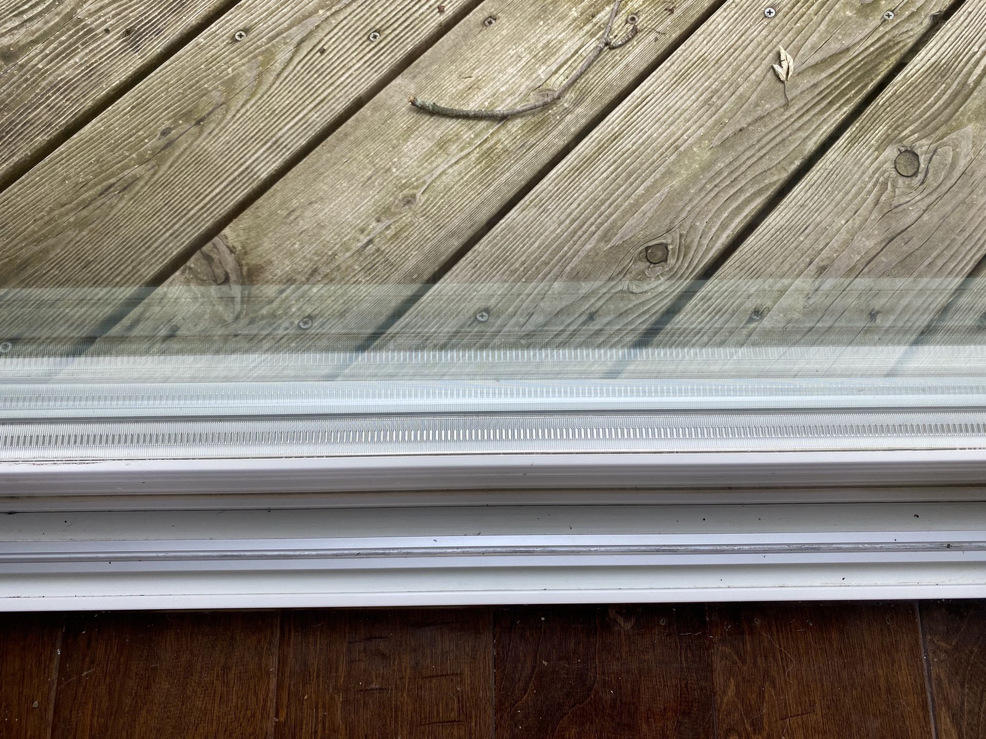 a close up of a window sill on a wooden deck .