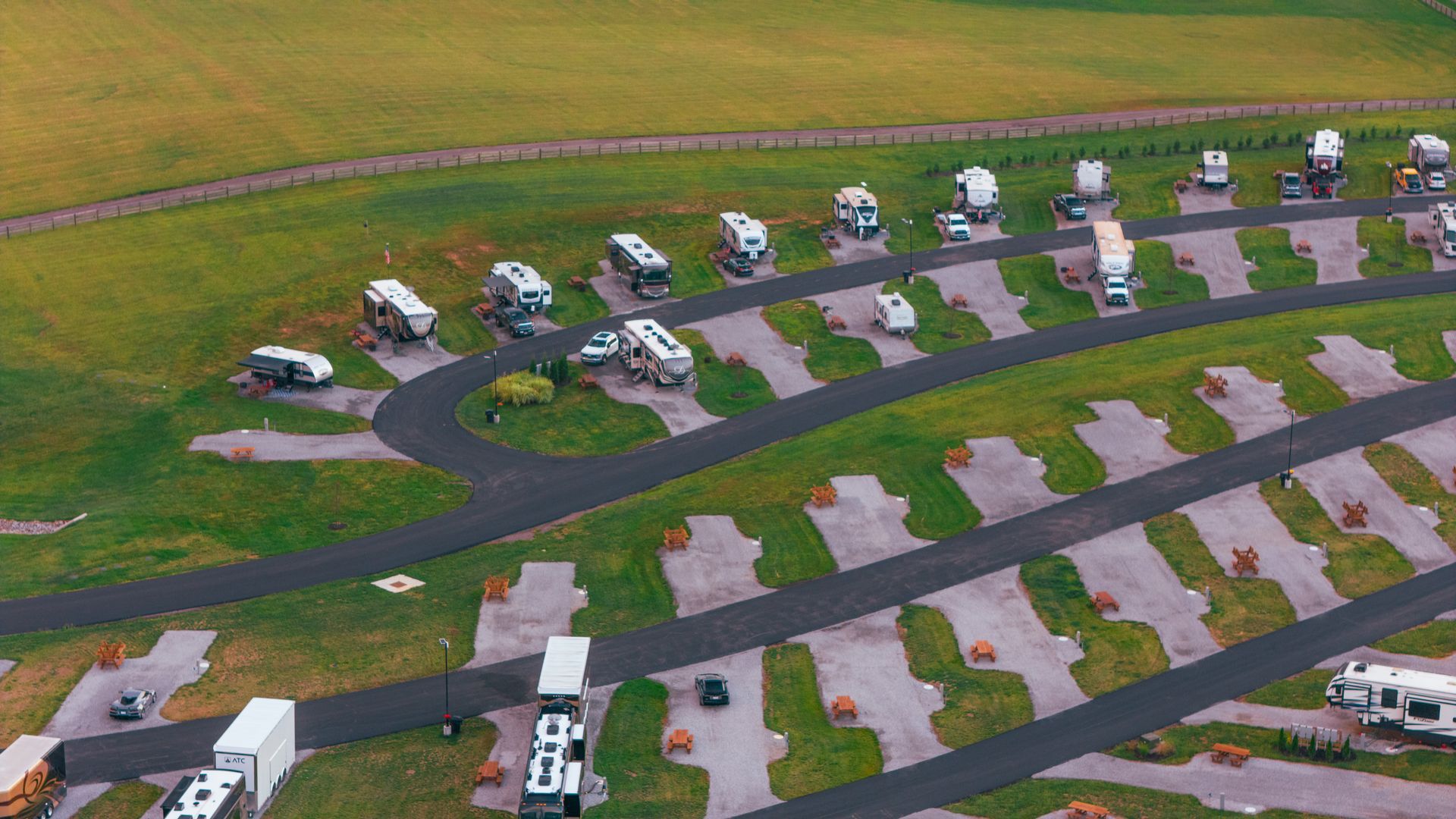A large rv is parked in a grassy area