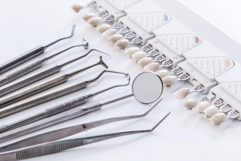 A bunch of dental instruments are sitting on top of a table.