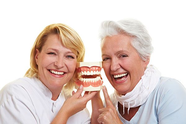 Benefits of Implant Anchored Dentures vs. Traditional Dentures
