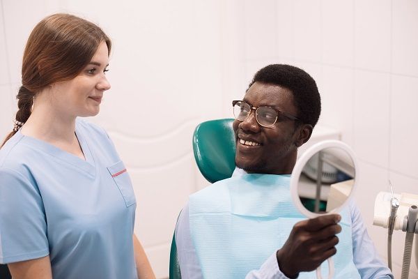 hygenist and man in a dental chair