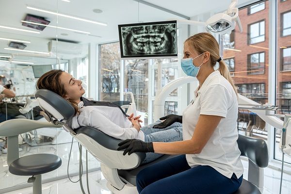 dental hygienist seeing a patient 