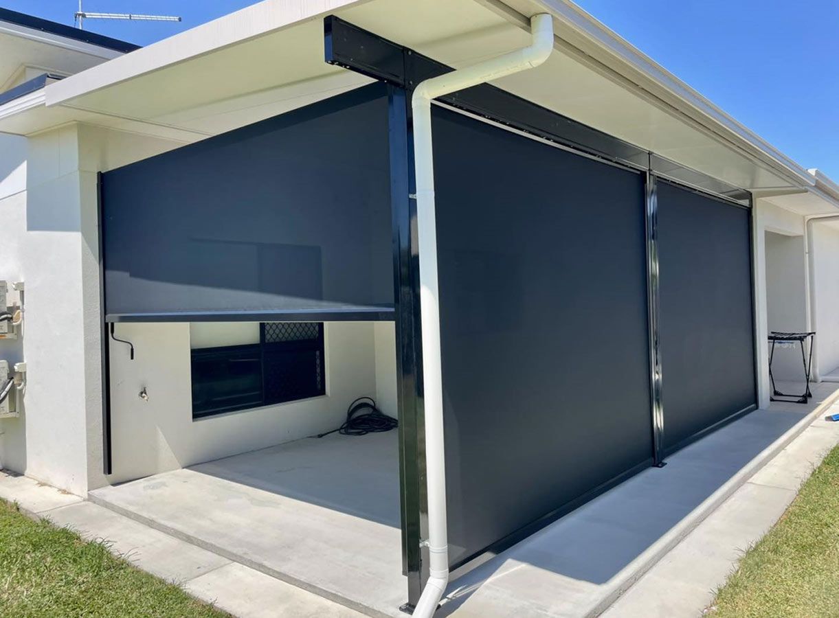A White House With a Black Awning on the Side of It — Cover Me NQ in Currajong, QLD