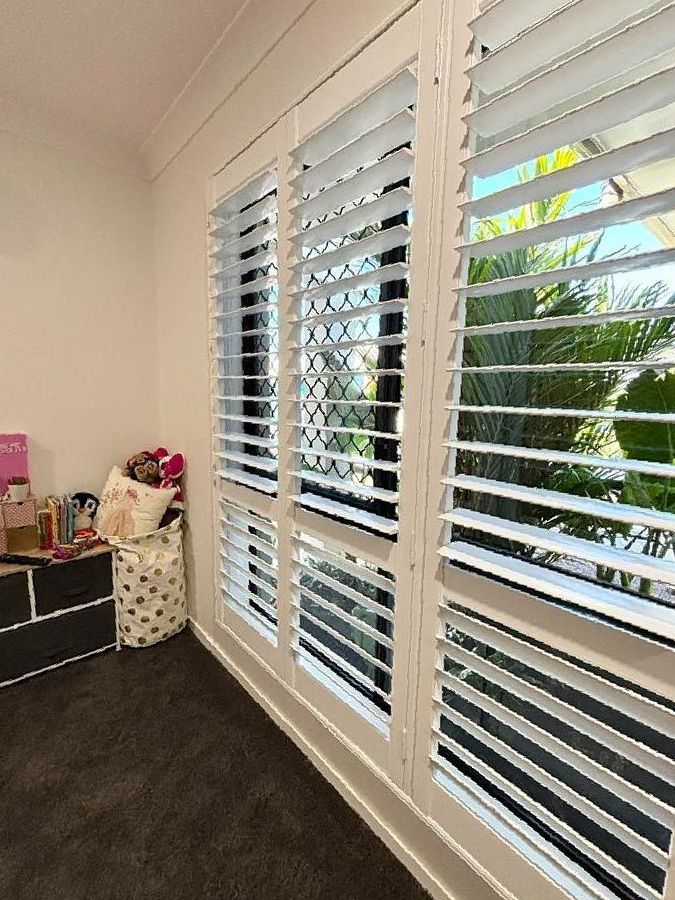A Room With a Lot of Windows and Shutters on Them — Cover Me NQ in Currajong, QLD