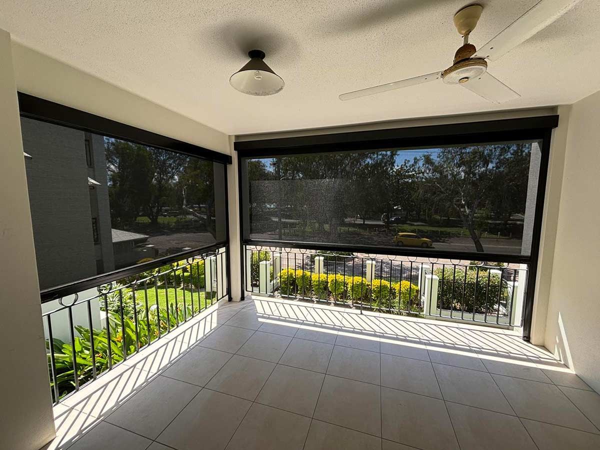 An Empty Room With a Ceiling Fan and a Screened in Porch — Cover Me NQ in Currajong, QLD