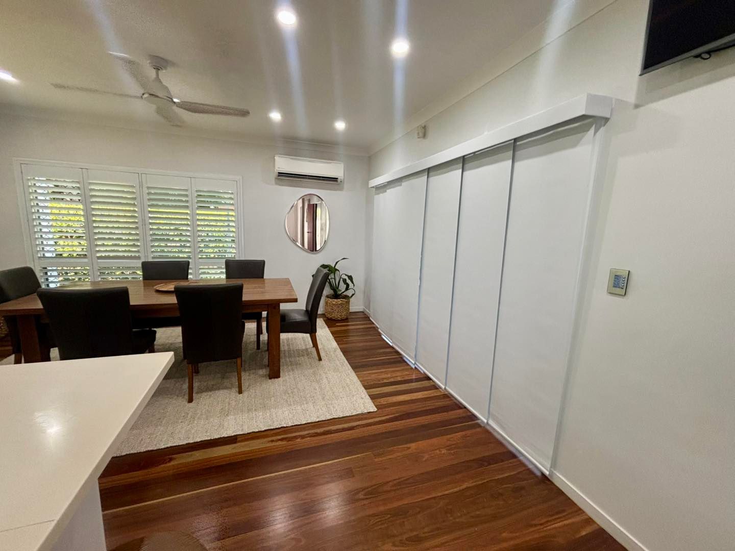 A Bedroom With a Bed and a Ceiling Fan — Cover Me NQ in Currajong, QLD