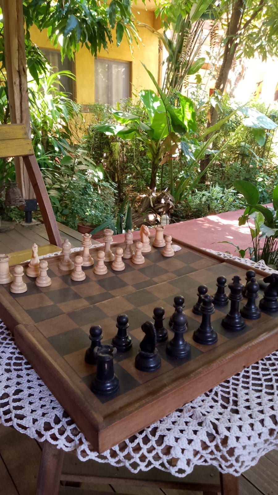 Una mesa de madera con un tablero de ajedrez y piezas de ajedrez sobre ella.