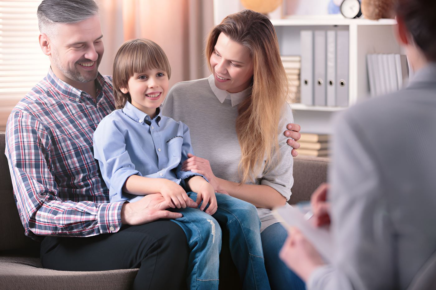 A Family is Sitting on a Couch Talking to a Counselor