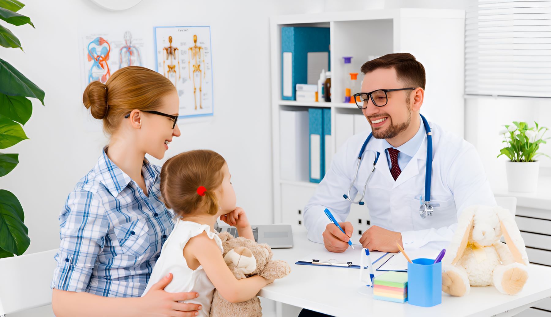 A Woman is Holding a Little Girl While Talking to a Doctor — Newcastle Paediatric Occupational Therapy in Charlestown, NSW