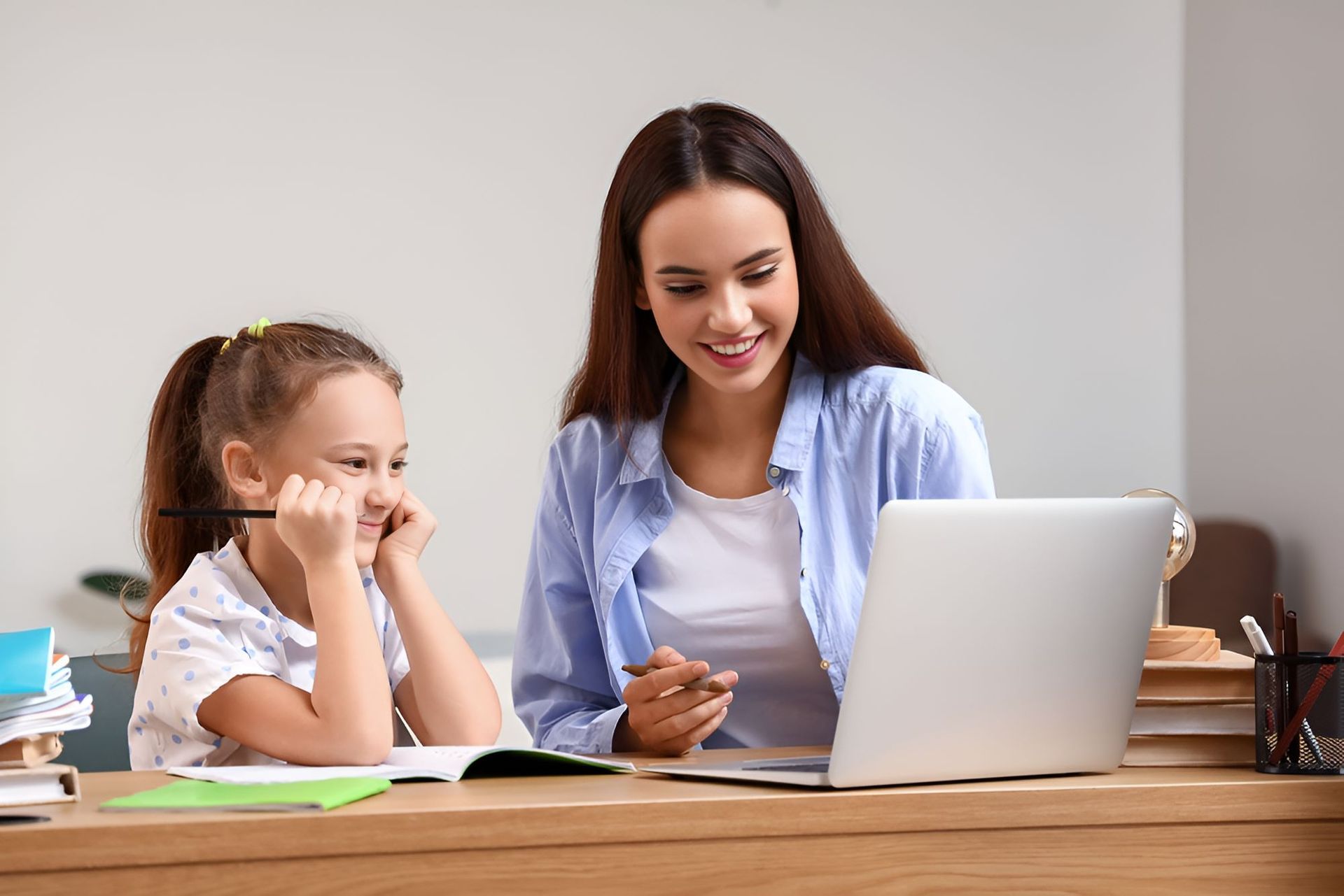 A Woman is Teaching a Little Girl — Newcastle Paediatric Occupational Therapy in Charlestown, NSW