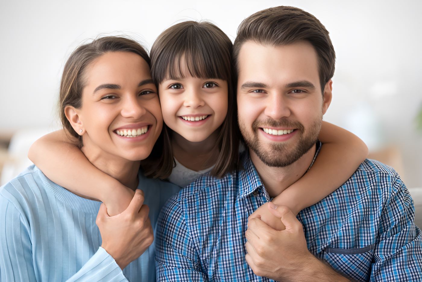 A Family is Posing for a Picture Together and Smiling — Newcastle Paediatric Occupational Therapy in Hunter Region, NSW