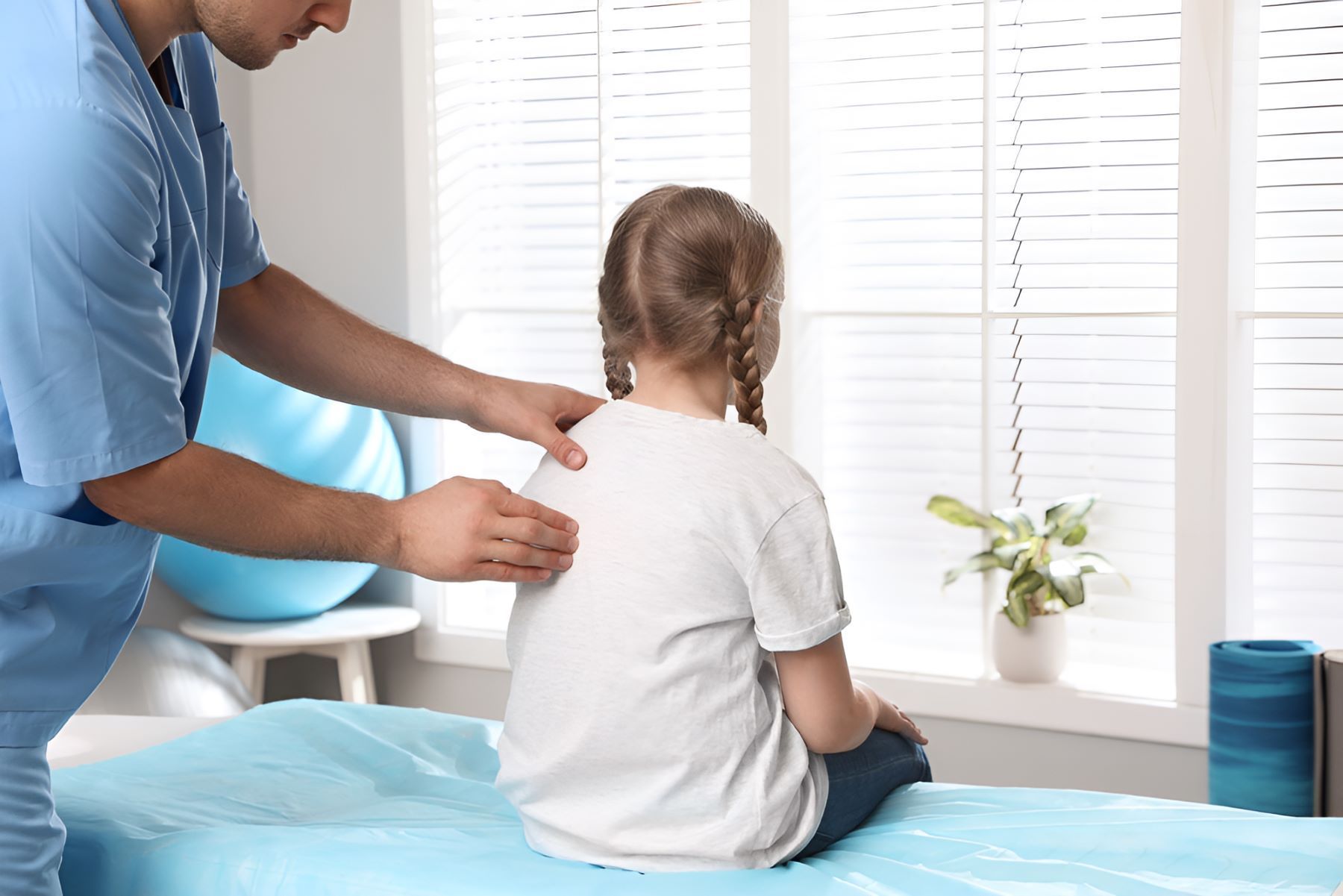 A Little Girl is Sitting on a Bed — Newcastle Paediatric Occupational Therapy in Lake Macquarie, NSW