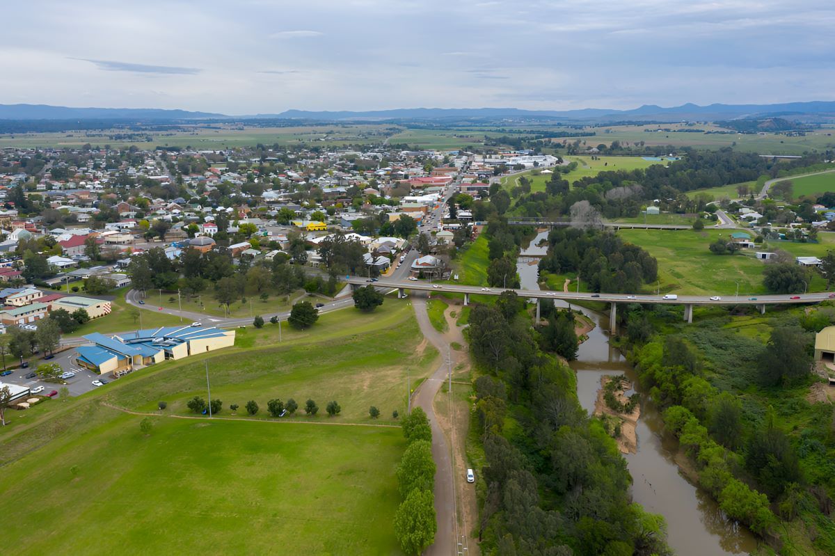 An Aerial View of a Small Town Next to a River and a Bridge — Newcastle Paediatric Occupational Therapy in Hunter Region, NSW