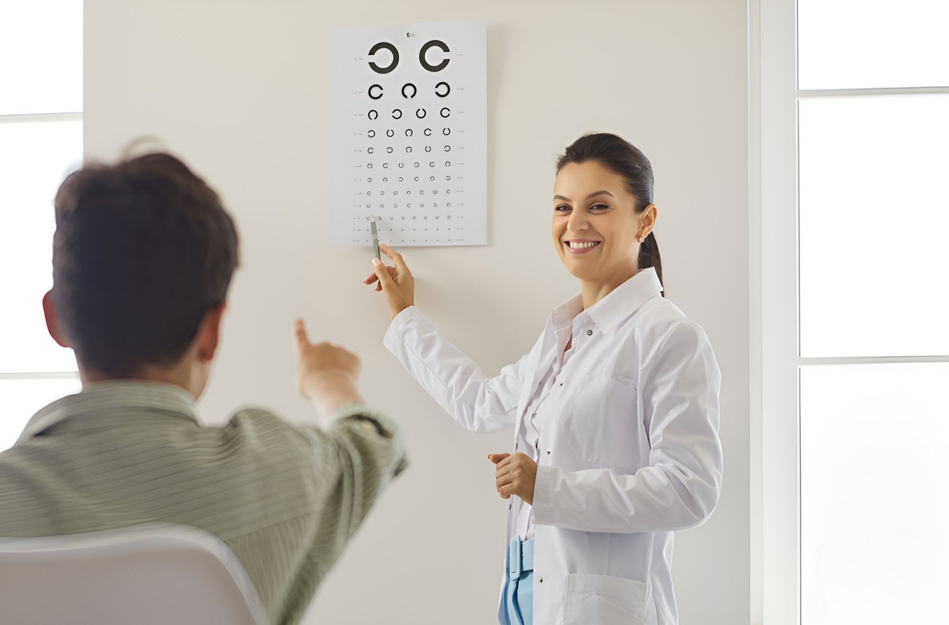 A Female Doctor is Giving a Child an Eye Exam — Newcastle Paediatric Occupational Therapy in Floraville, NSW