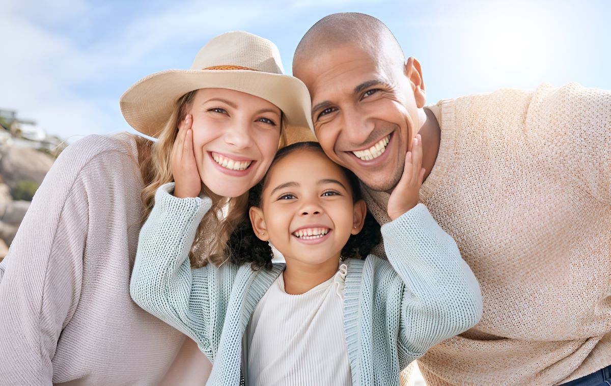 A Family is Posing for a Picture on the Beach — Newcastle Paediatric Occupational Therapy in Merewether, NSW
