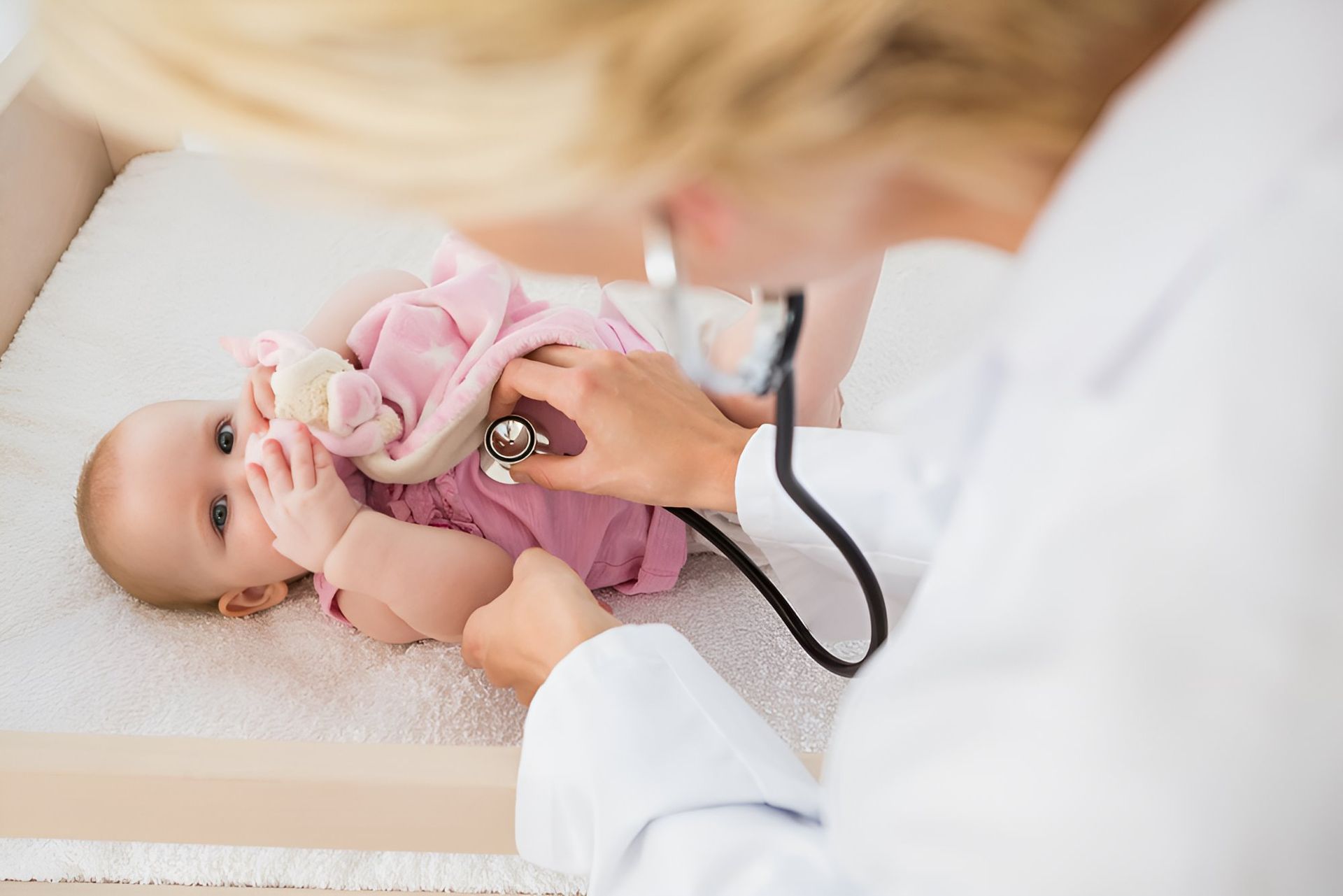 A Doctor is Examining a Baby With a Stethoscope — Newcastle Paediatric Occupational Therapy in Newcastle, NSW