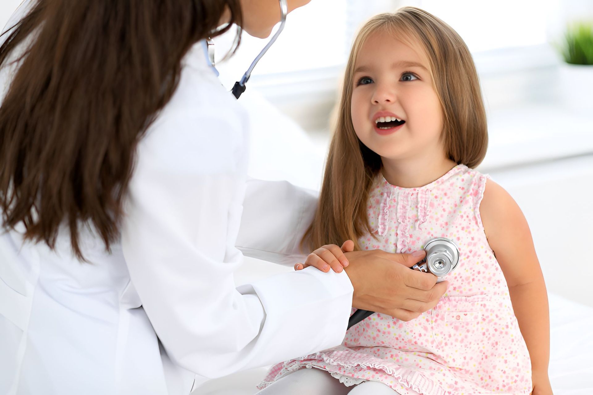 A Little Girl is Being Examined by a Doctor With a Stethoscope — Newcastle Paediatric Occupational Therapy in Floraville, NSW
