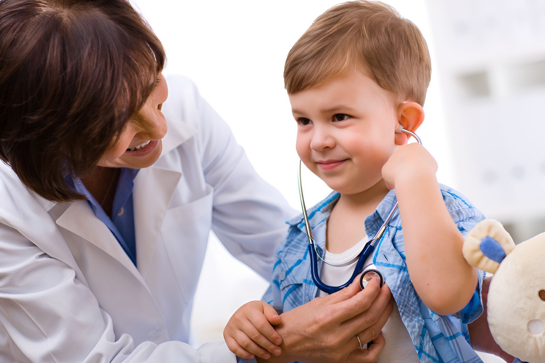 A Doctor is Examining a Young Boy With a Stethoscope — Newcastle Paediatric Occupational Therapy in Swansea, NSW